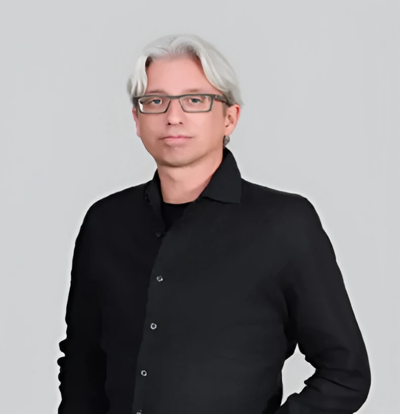 Person with gray hair posing confidently